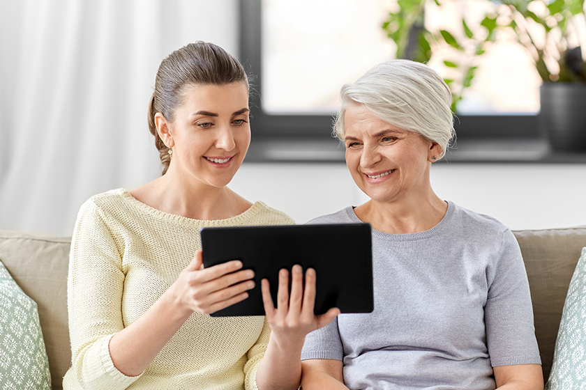 Daughter and senior mother with tablet