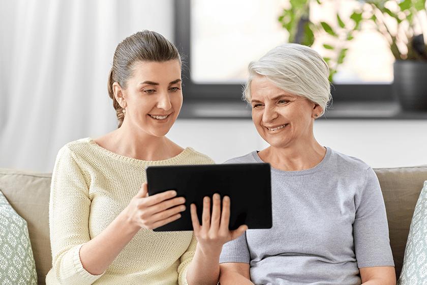 Daughter and senior mother with tablet